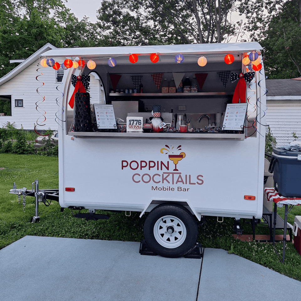 Poppin Cocktails mobile bar trailer at a 4th of July party in 2026