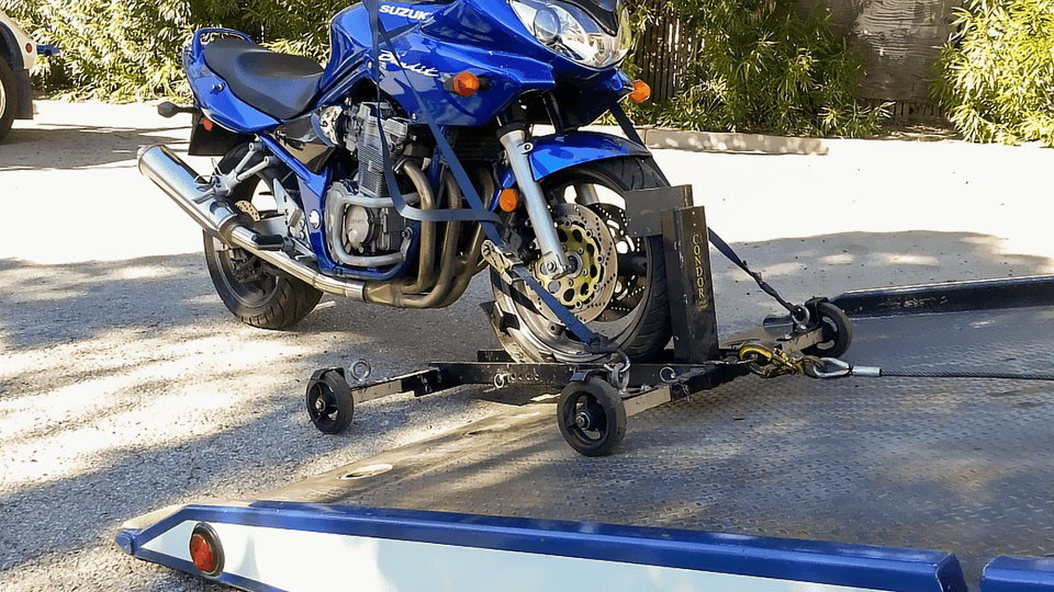 Motorcycles require secure handling, wheel chocks, soft straps, and flat surface support to prevent tipping, scratching, or shifting. Our team uses specialized cradles or trailers designed specifically for bikes to ensure safe transport.