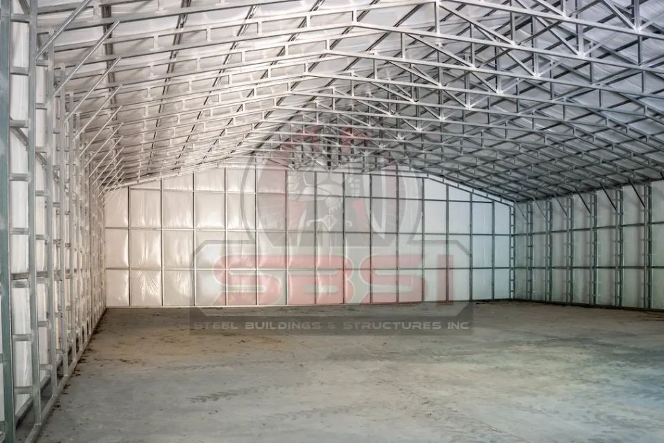 Empty steel building, with SBSI watermark representing steel building interiors in Alabama