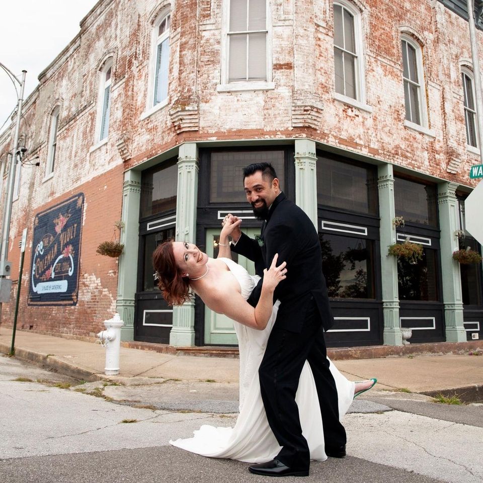 Groom dipping bride outside coleman vault