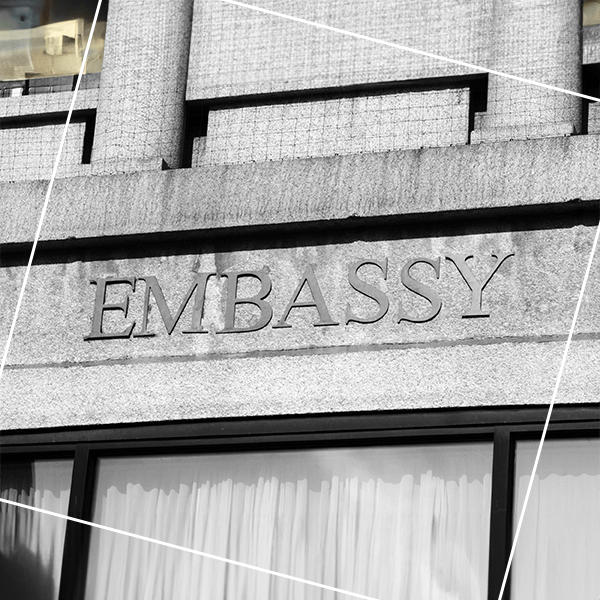 The word embassy on side of building