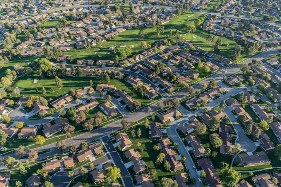 Aerial drone view of Granite Bay, California, featuring luxury estate homes, granite rock outcroppings, and the lush oak tree canopy overlooking Folsom Lake.