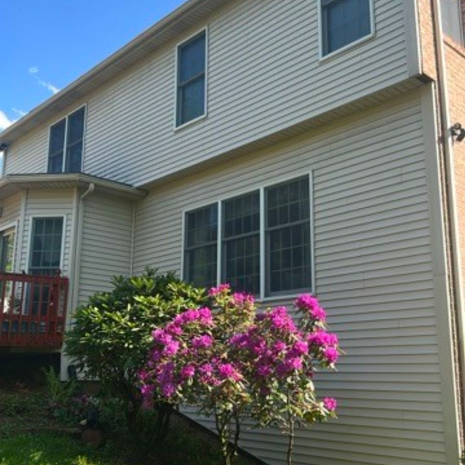 Clean vinyl siding on two-story home after pressure washing service in Harrisburg PA