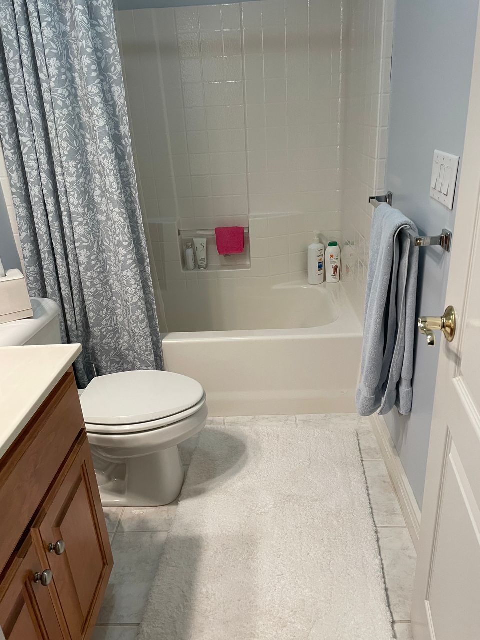 Clean bathroom with tub shower and tidy vanity after a house cleaning service in Virginia Beach VA