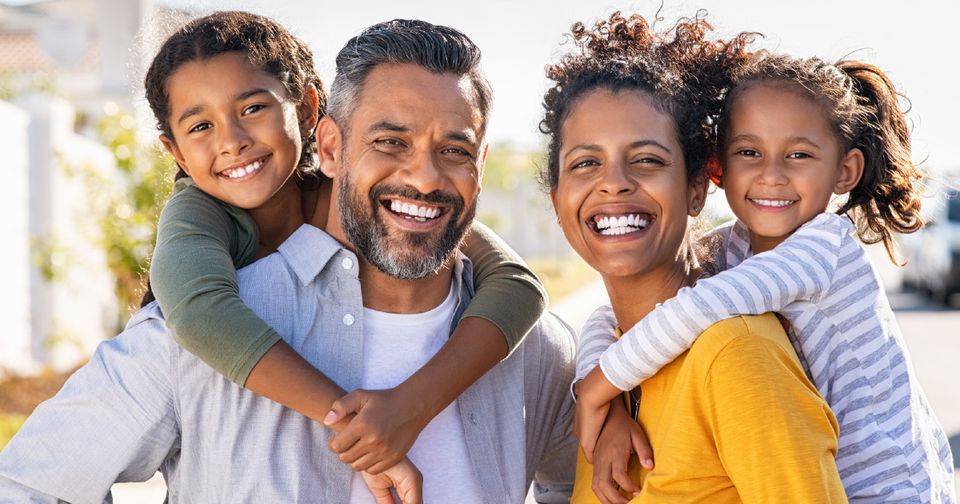 Family smiling outside