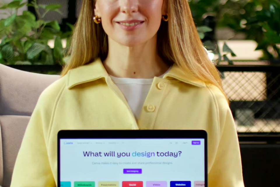 Professional designer presenting the Interactive Brand Hub on a laptop screen, symbolizing creative digital portfolio solutions and business professionalism.