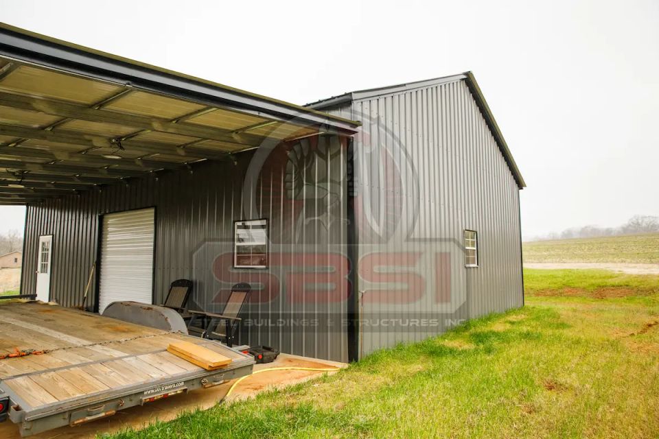 Dark gray steel building with covered lean to and side windows with SBSI watermark representing steel buildings in Alabama