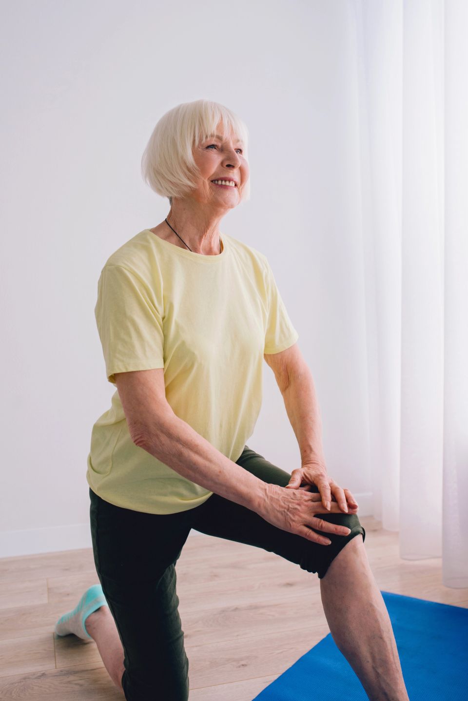 Senior woman doing yoga indoors