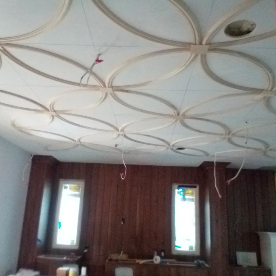 Decorative circular trim molding installed on a ceiling during an interior remodeling project
