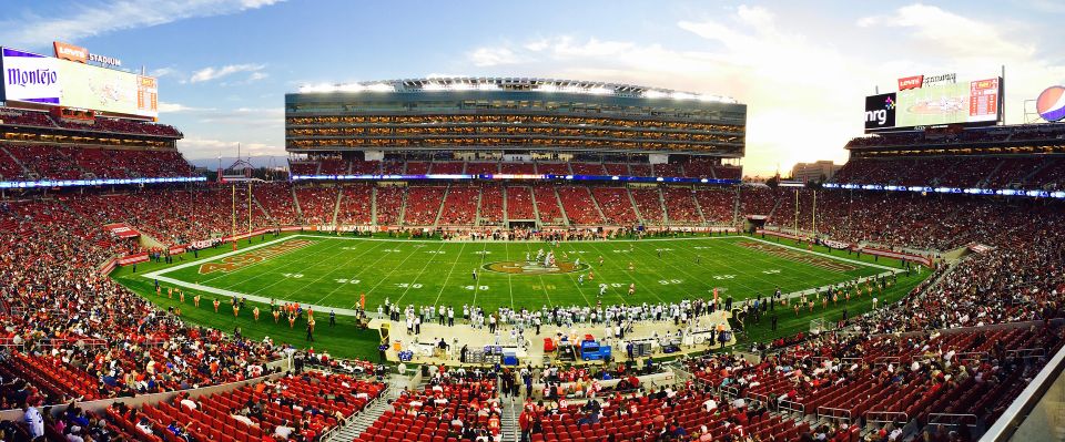 Football stadium full of lively people and athletes ready to start game
