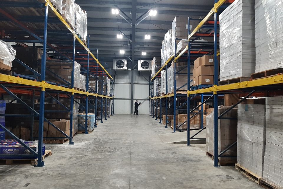 Large warehouse with industrial shelving and packaged inventory.