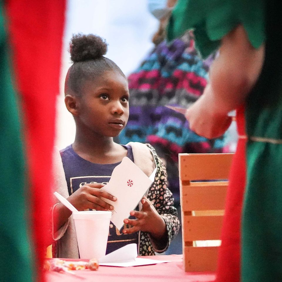 Elves help a young lady with her letter for santa   december