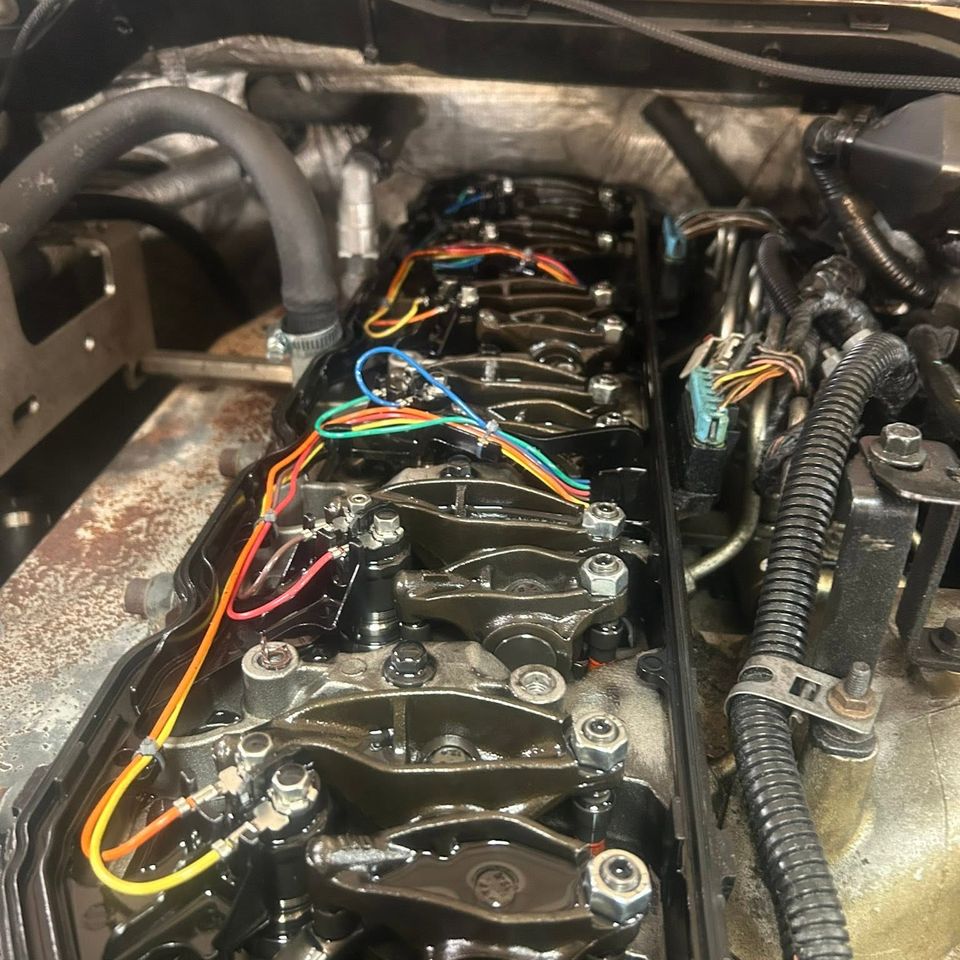 Diesel engine valve train with color-coded injector wiring during head service in Arab Alabama