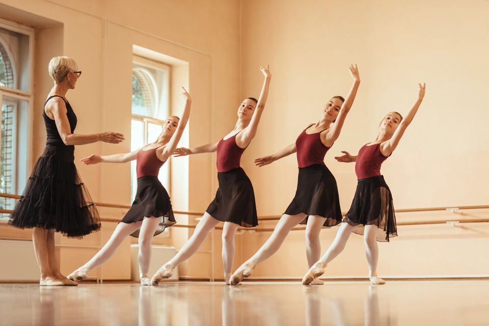 Ballerinas practicing in their ballet school with their teacher
