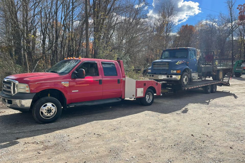 Figs towing red truck flatbed
