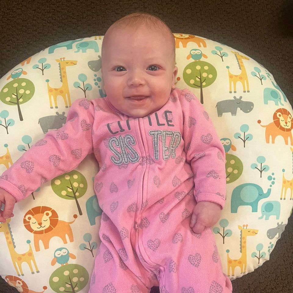 Infant in a pink onezee