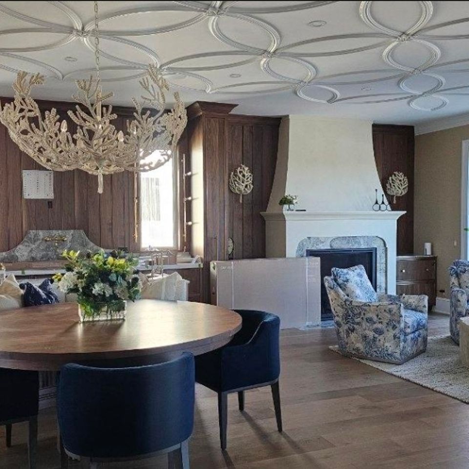 Formal dining room with decorative ceiling trim wood paneling and hardwood flooring in Chagrin Falls
