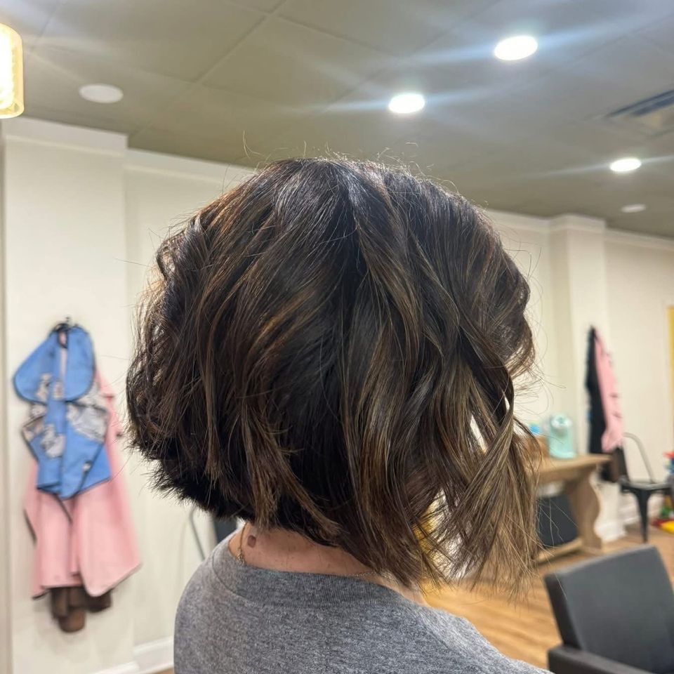 Short dark angled bob with soft caramel highlights and waves styled in Columbiana AL