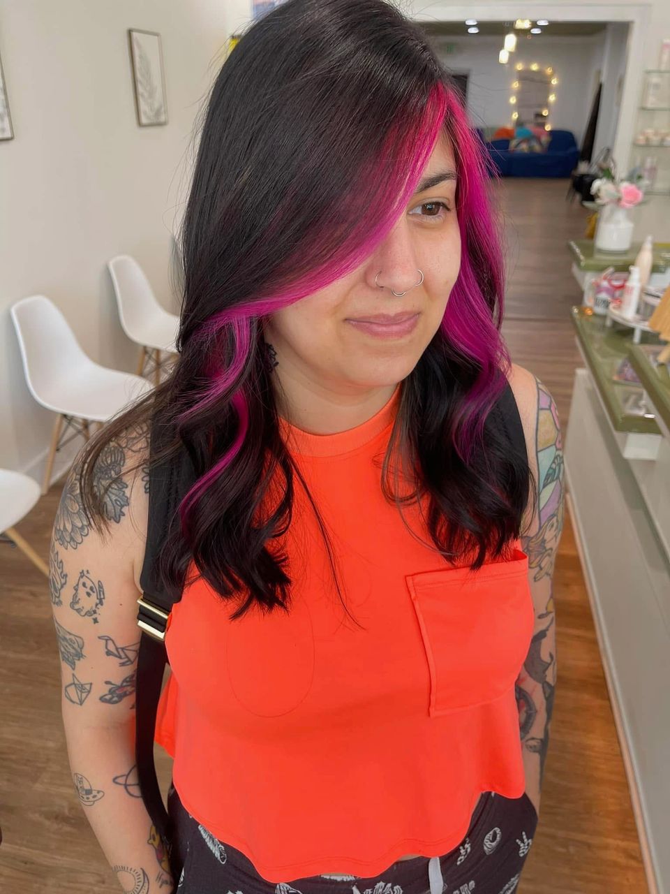 Dark hair with vivid magenta money piece framing the face after color service in Columbiana AL