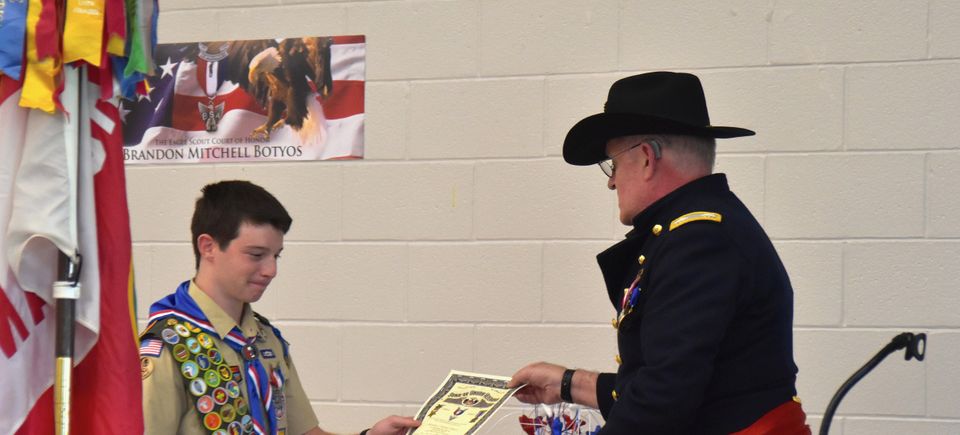 John schneider, sr. presents certificate to eagle scout brandon botyos