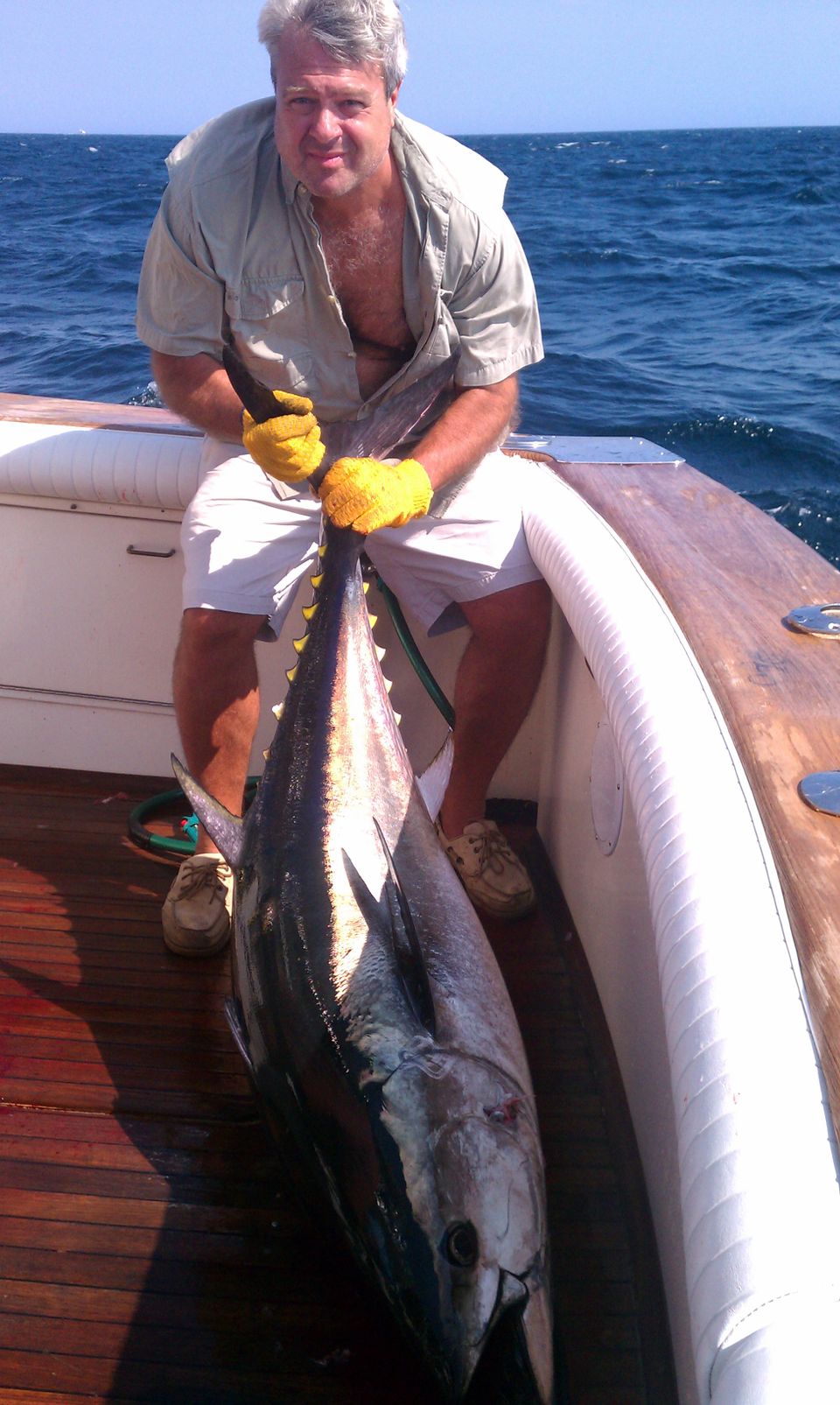 Man on boat holding tuna2