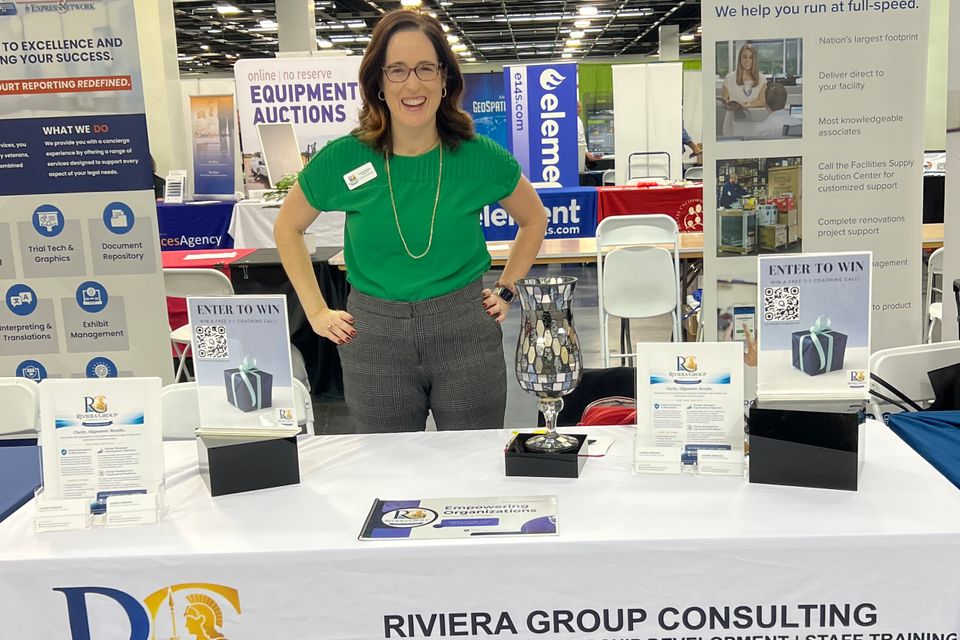 Woman standing by event table