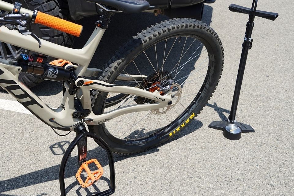 Bike stand holding mountain bike next to air pump
