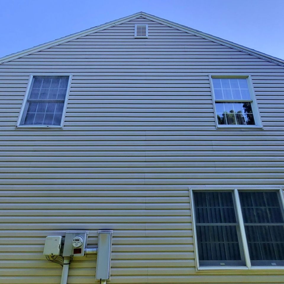 Two-tone gray and yellow vinyl siding after house washing service in Harrisburg PA