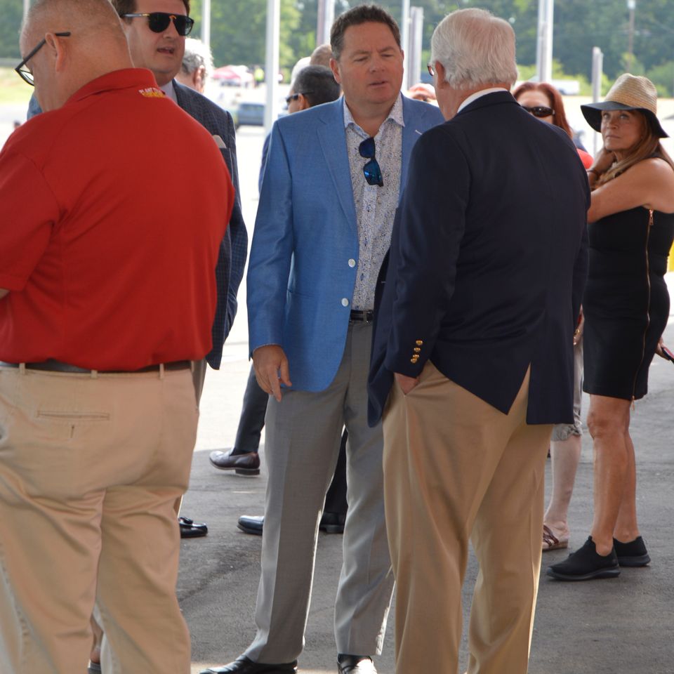Dignitaries chat before the ribbon cutting