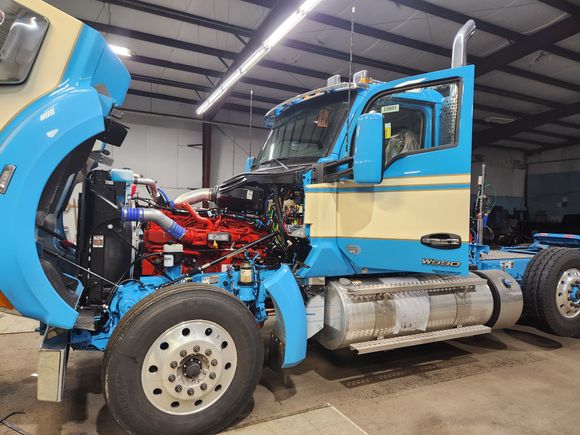 Industrial forklift receiving professional glass repair and windshield replacement service.