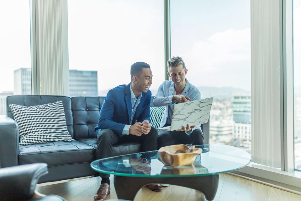 Business owner showing project to client in a fancy conference room