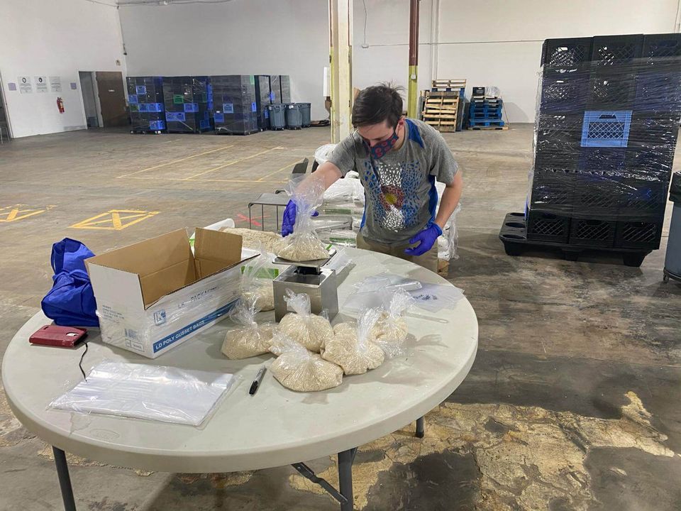 Colbin Lindsley measuring out food for donations