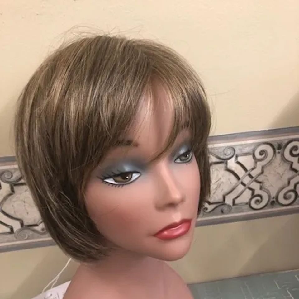 Short brunette bob wig with side-swept bangs and subtle layered styling displayed on a mannequin at Shears Wigs & Hairpieces Salon.