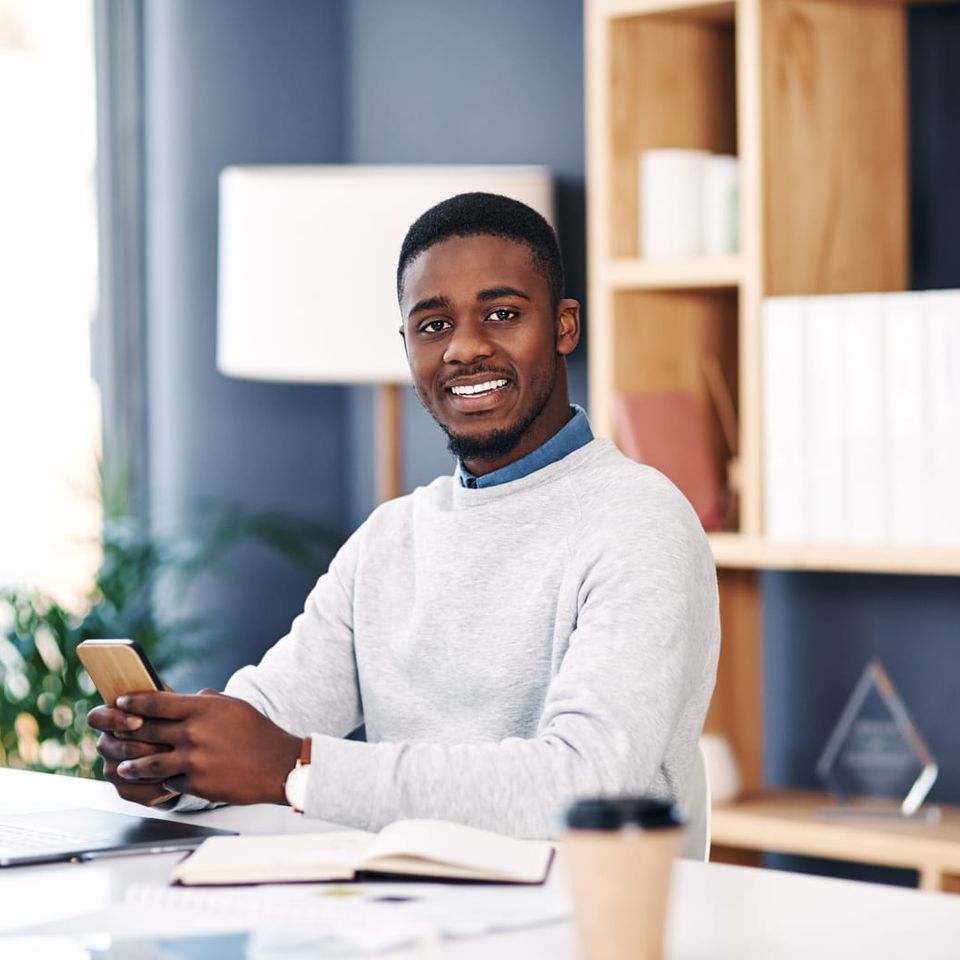 59609106 black man smile and portrait with smartphone in office for web design online project or social media happy business person and mobile with internet for work research planning or communication