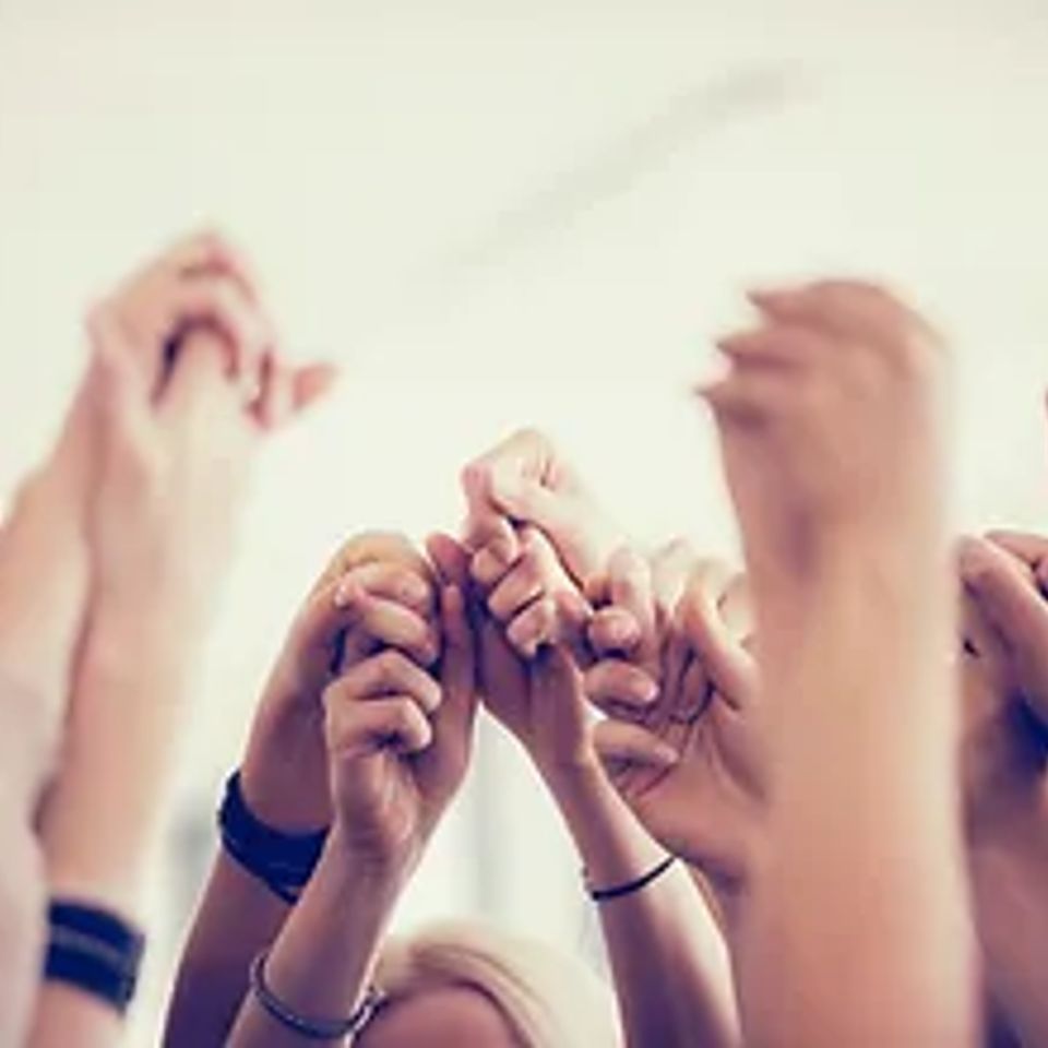 Trinitywomen holding hands