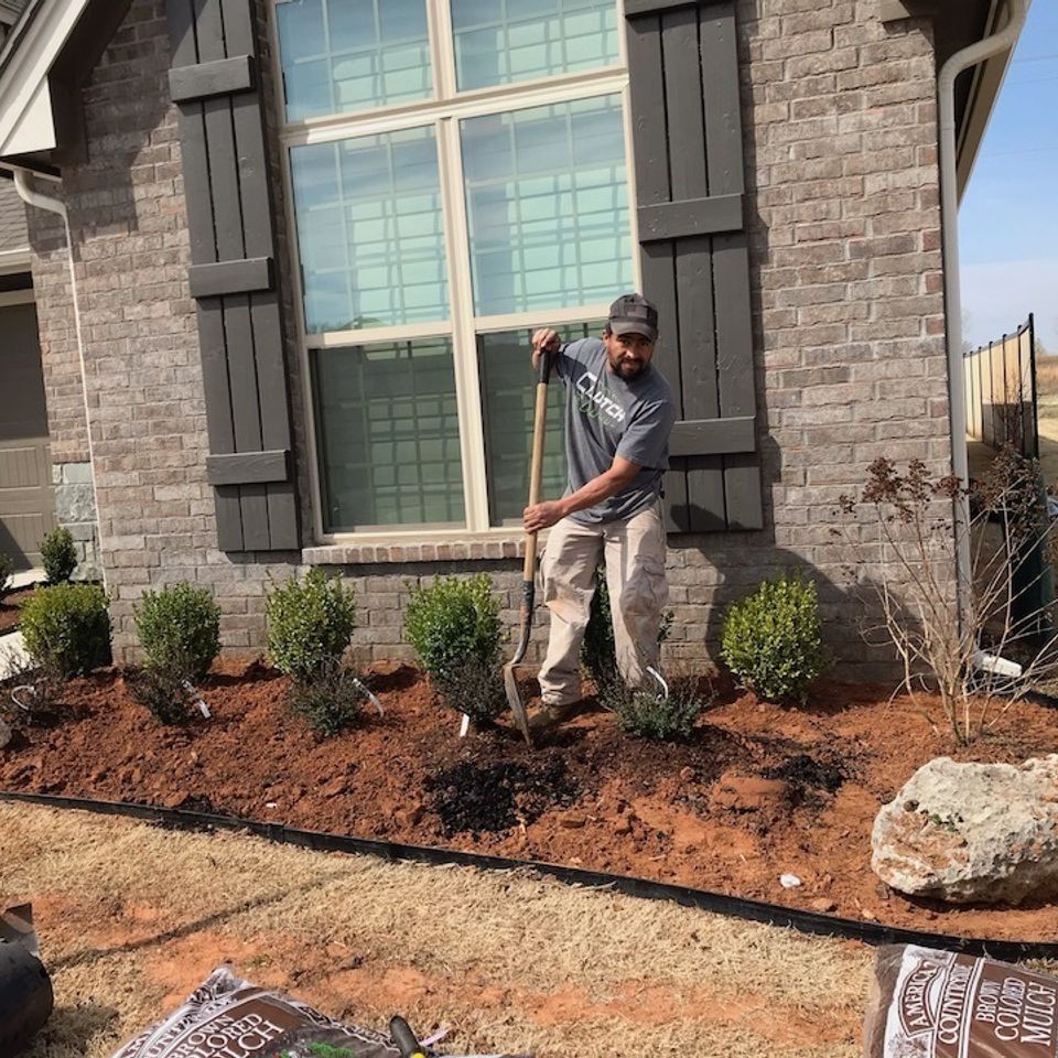 Landscaping solutions   tulsa oklahoma   hector working on a flowerbed install   image5 2
