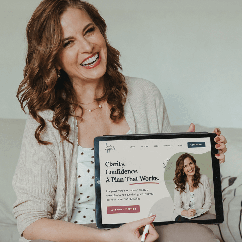 Trina holding up website square