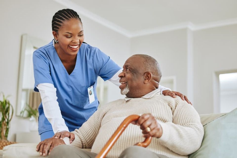 Caregiver laughing and talking with patient to build relationship