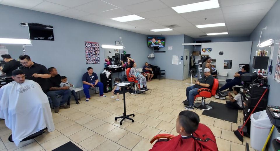 Interior view of busy Uppercuts Loma Linda barbershop with many customers