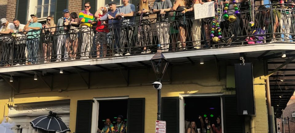VIP Mardi Gras balcony at The Swamp 516 Bourbon Street overlooking the Bourbon Street crowds in New Orleans