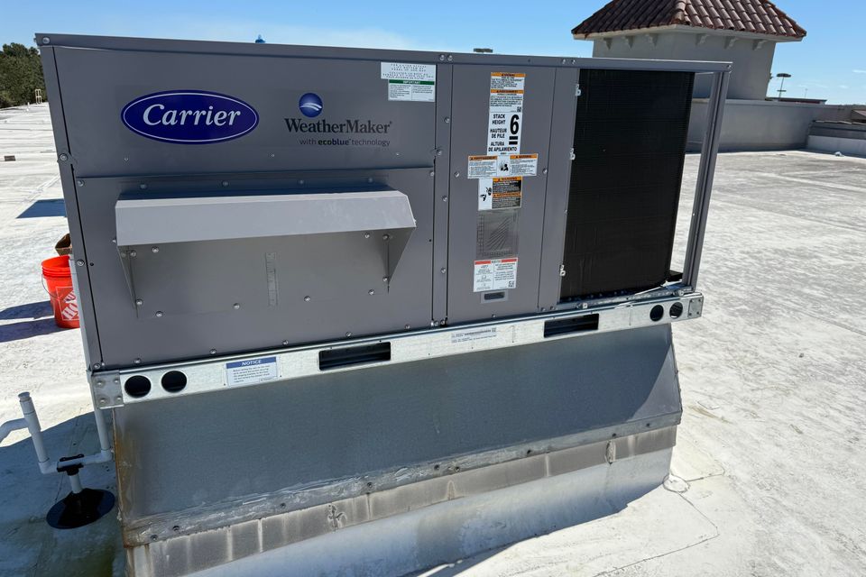 Large Weather Maker unit built by carrier on the roof of a commercial building.