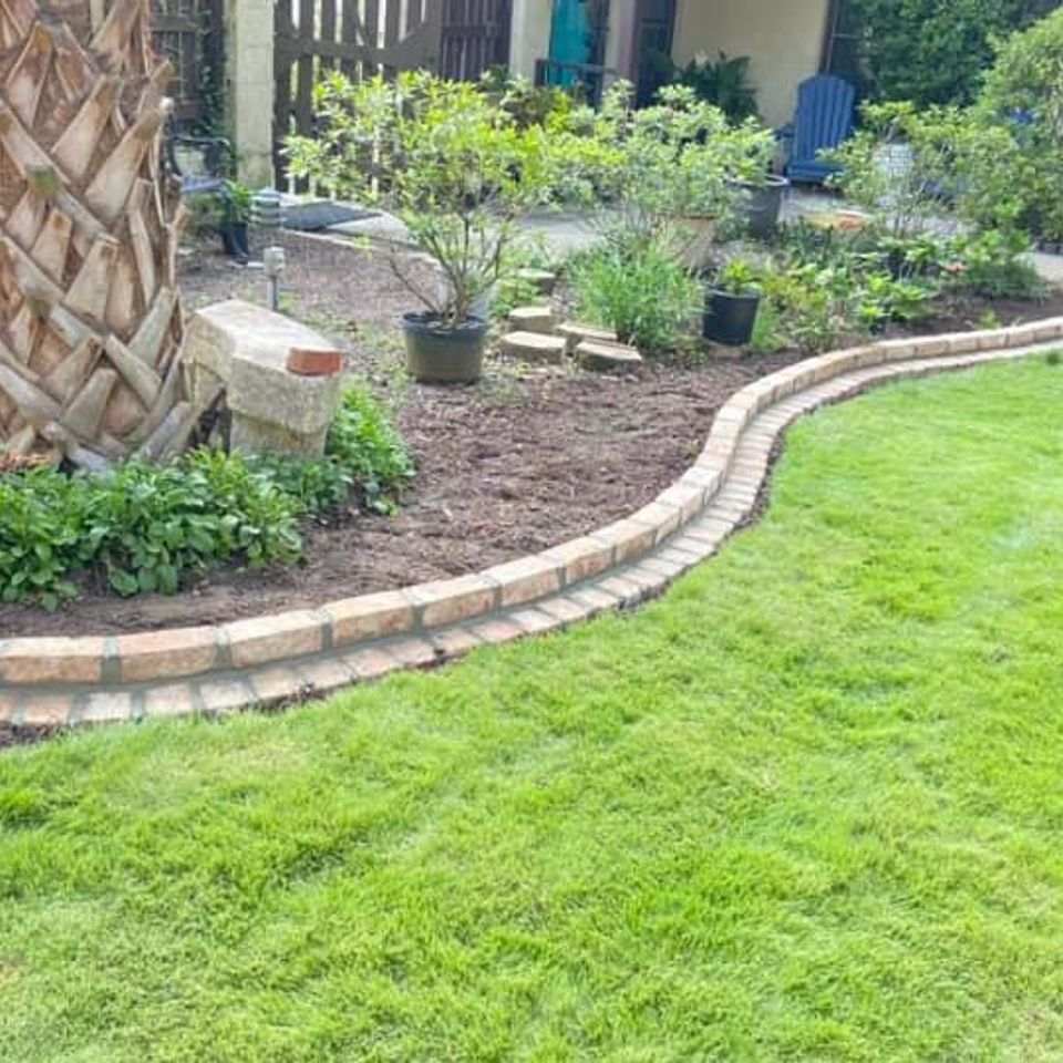 "Decorative stone landscape edging installed by Gabino Landscaping in Myrtle Beach, South Carolina."