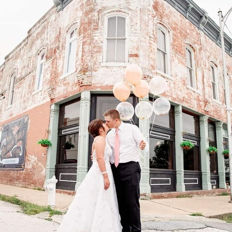 bride and groom with balloons at the coleman vault