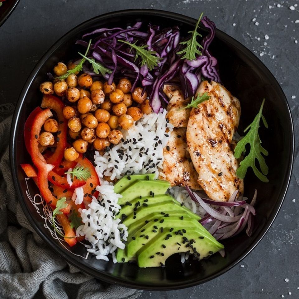 Grilled chicken rice and chick peas in a bowl trimmed