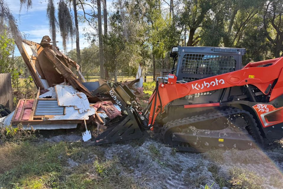 JNJ Hauling Solutions using the Kubota to remove junk
