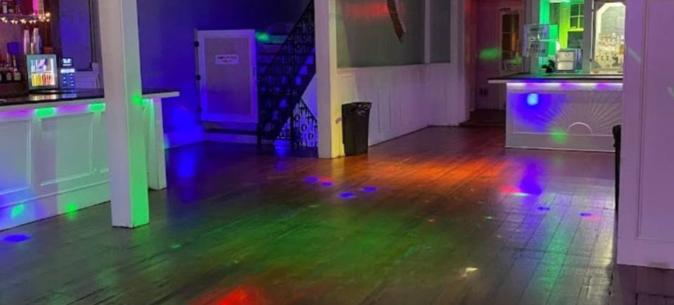 Interior of The Swamp at 520 Bourbon Street with dance floor and party lighting for Carpe Diem Events VIP balcony parties.