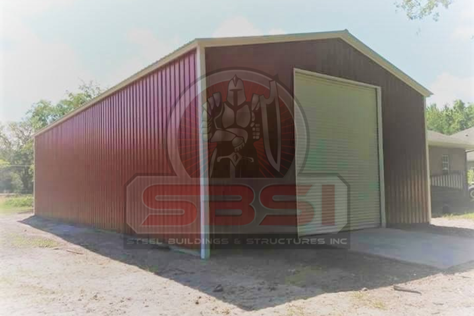 Red and tan steel garage with roll up door and metal roof with SBSI watermark representing steel barns in Alabama