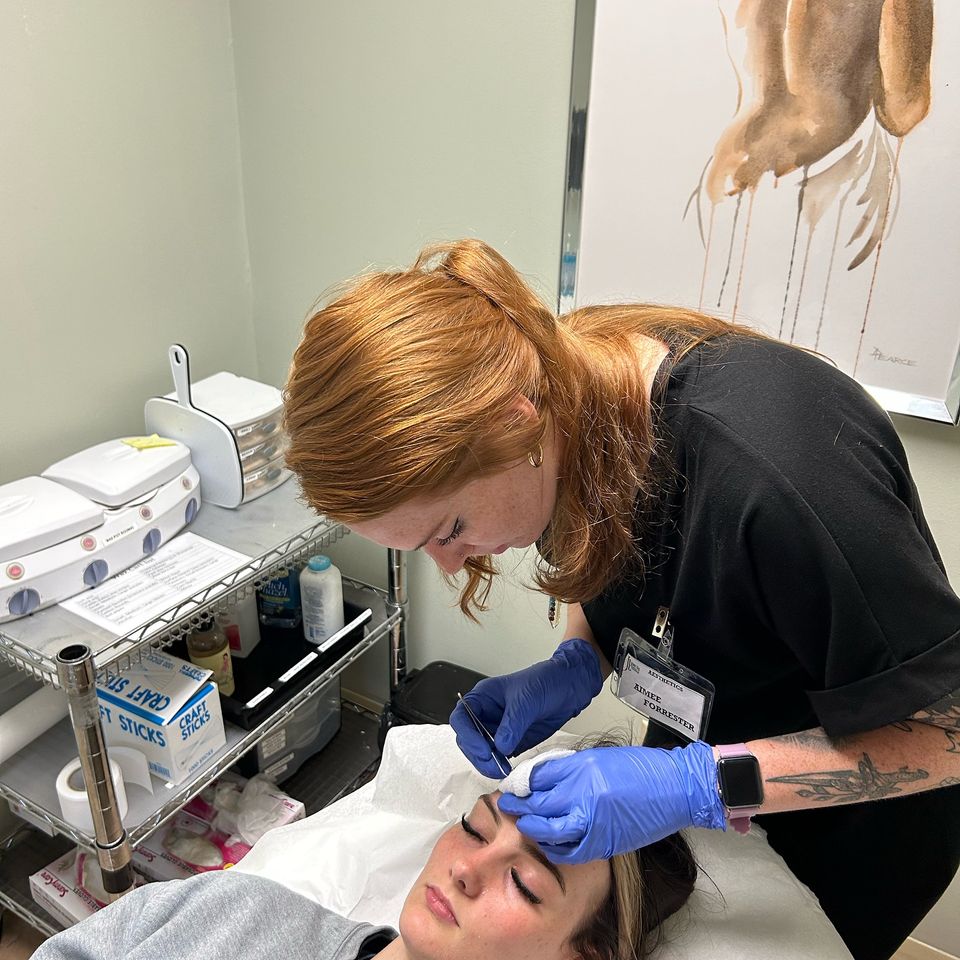 Esthetician student performing facial treatment in skincare training program