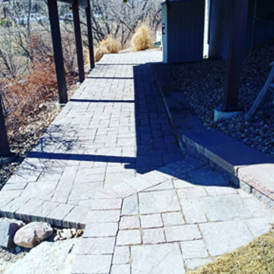 Paver patio with step and retaining wall wcap.