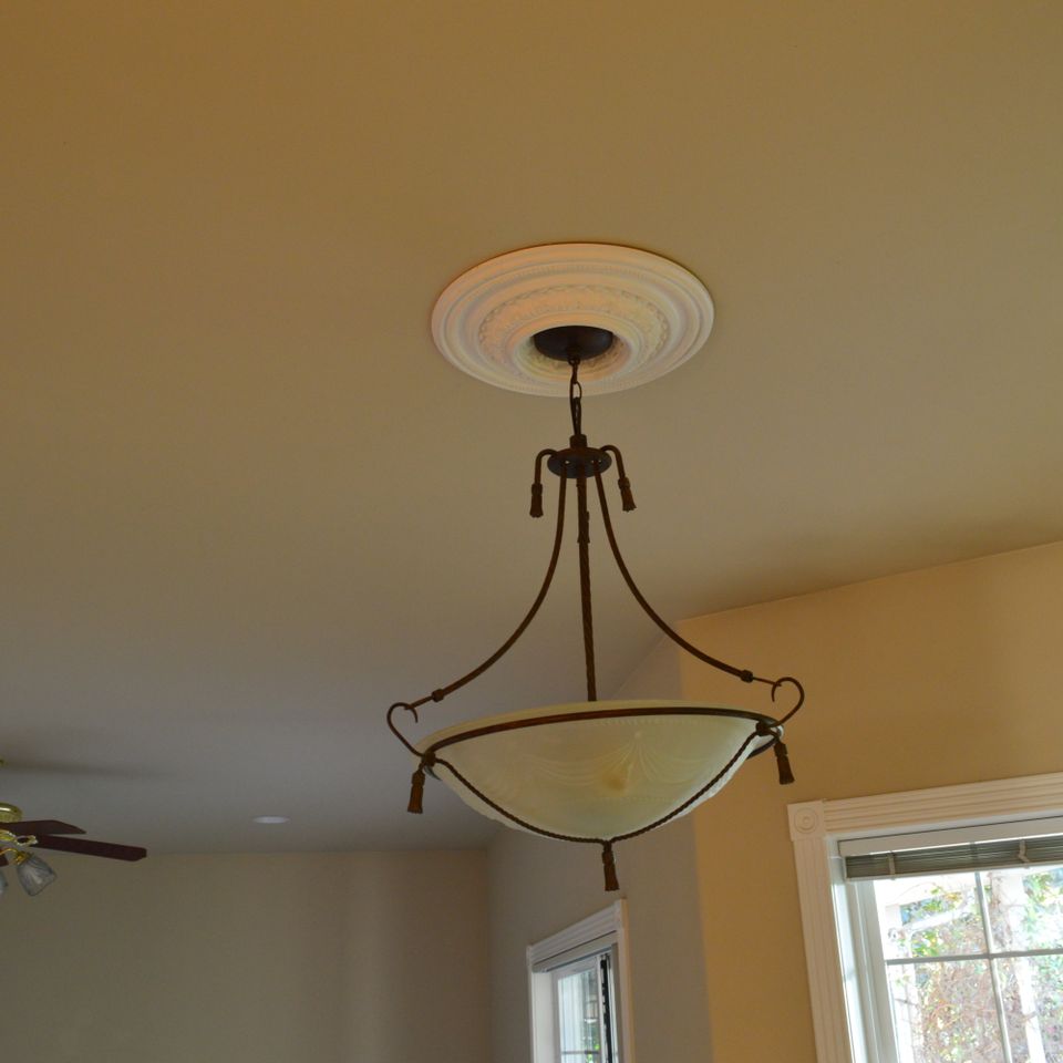 Pendant light fixture and ceiling medallion installed in a finished custom home interior